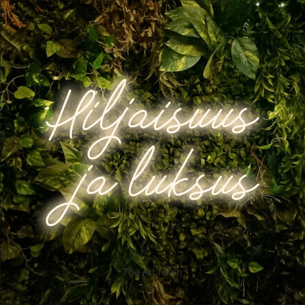 LED neon sign reading “Hiljaisuus ja luksus”, arranged in 2 lines.