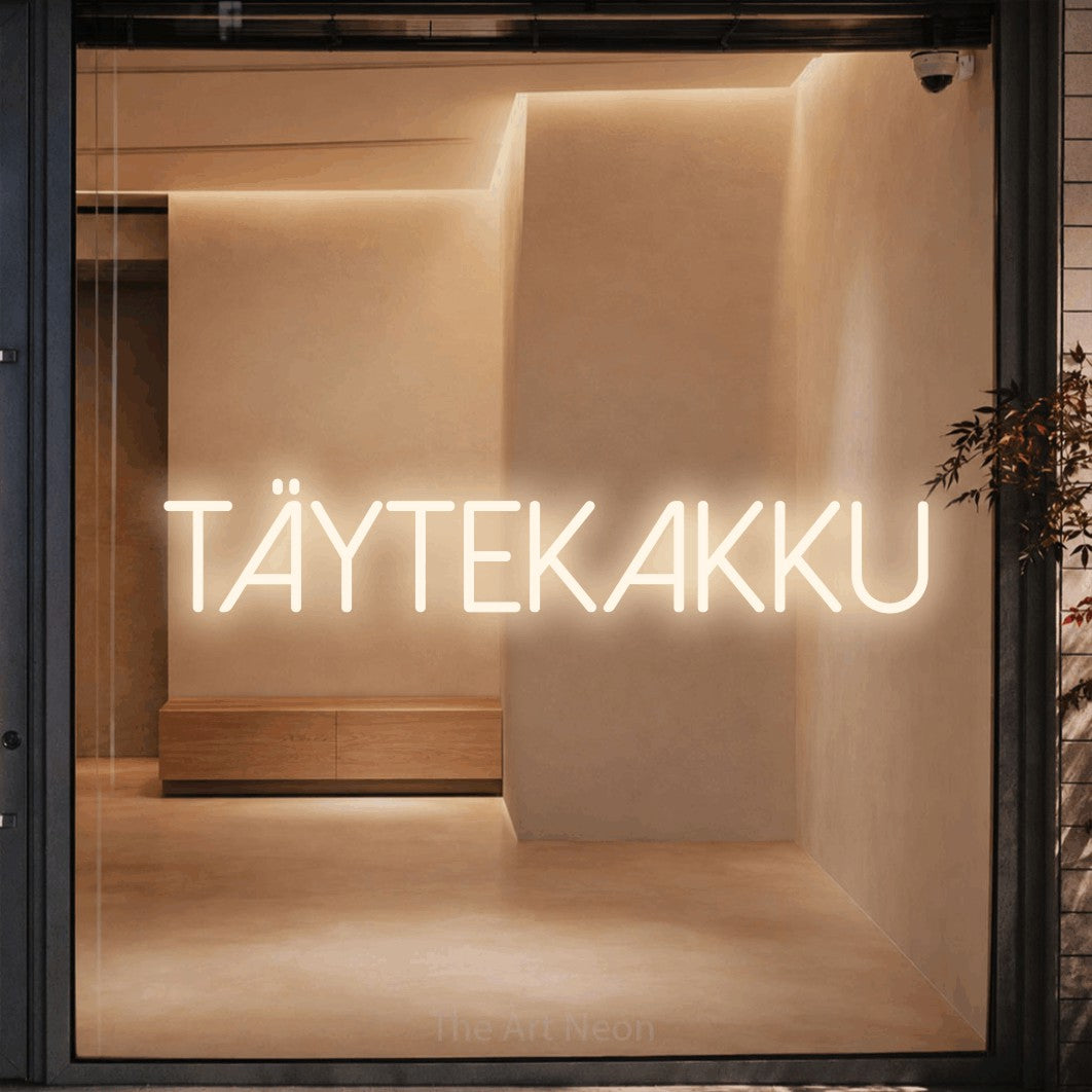 LED neon sign reading “TÄYTEKAKKU”, arranged in a single line.
