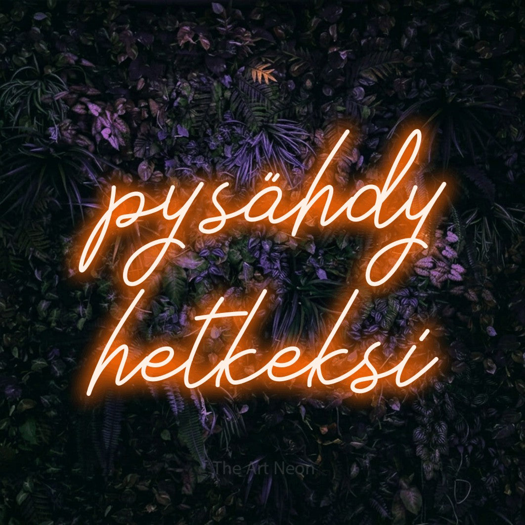 LED neon sign reading “pysähdy hetkeksi”, arranged in 2 lines.