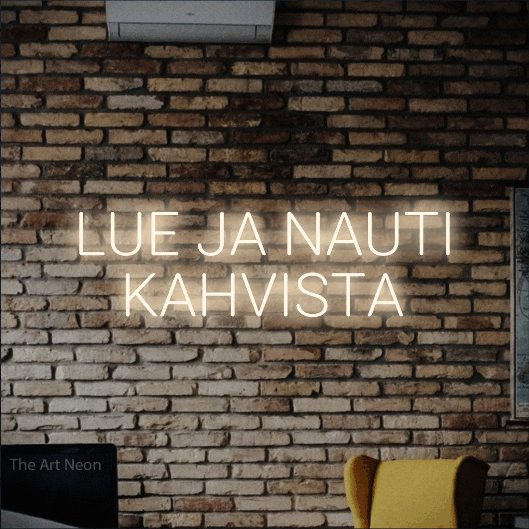 LED neon sign reading “LUE JA NAUTI KAHVISTA”, arranged in 2 lines.