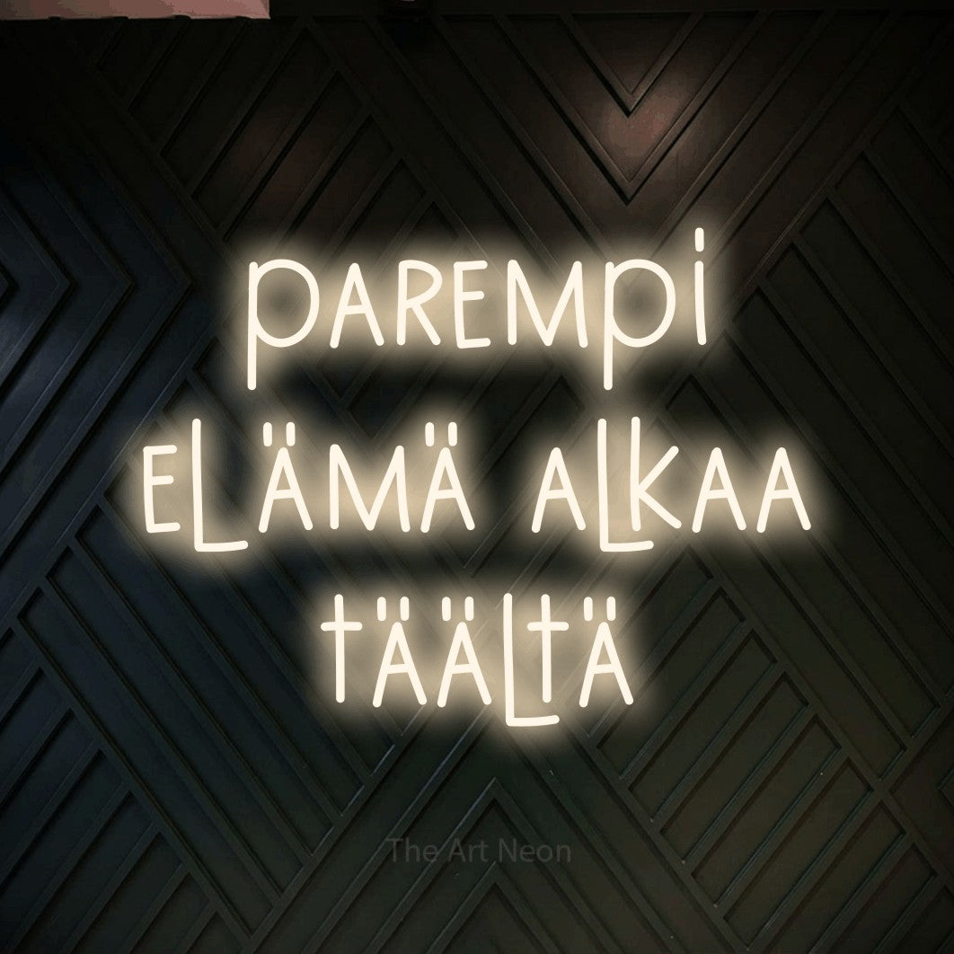 LED neon sign reading “parempi elämä alkaa täältä”, arranged in 3 lines.