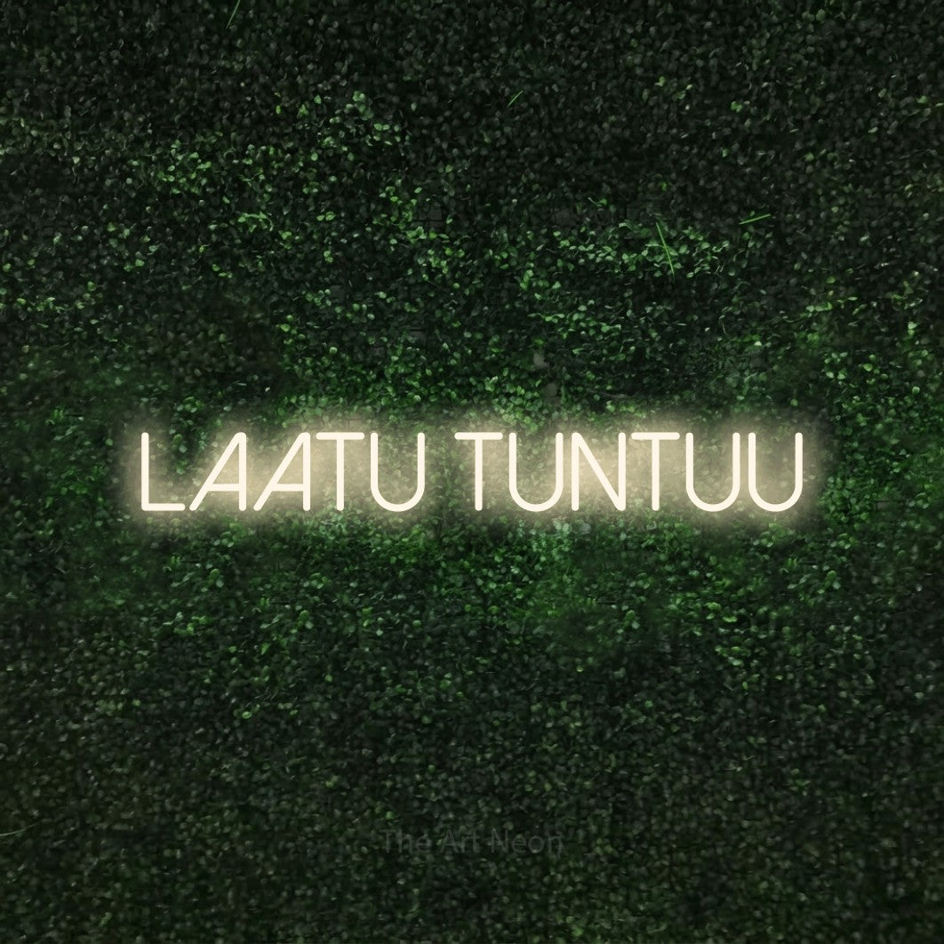 LED neon sign reading “Laatu tuntuu”, arranged in a single line.