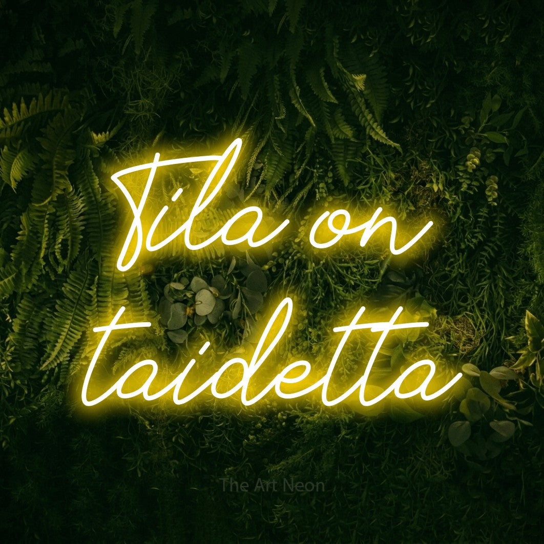LED neon sign reading “Tila on taidetta”, arranged in 2 lines.