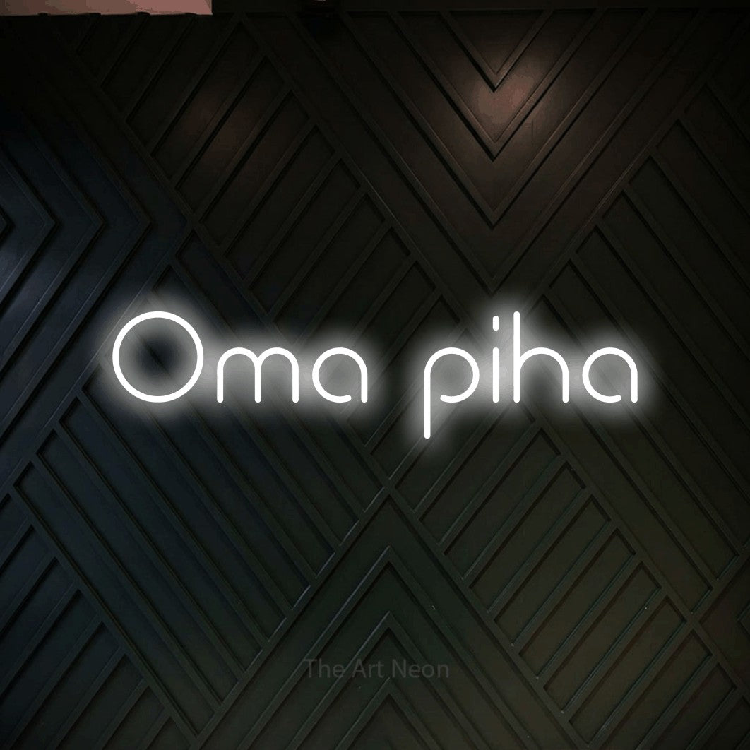 LED neon sign reading “Oma piha”, arranged in a single line.