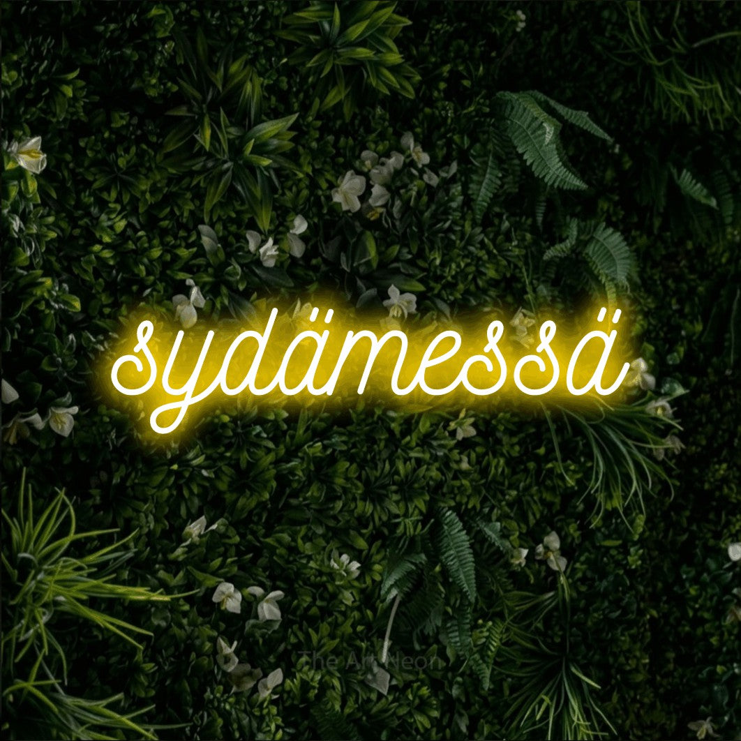 LED neon sign reading “sydämessä”, arranged in a single line.