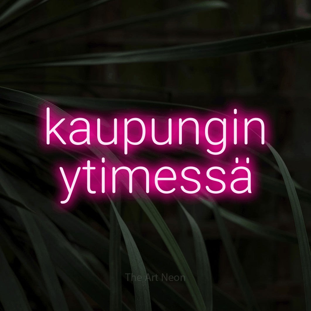 LED neon sign reading “kaupungin ytimessä”, arranged in 2 lines.