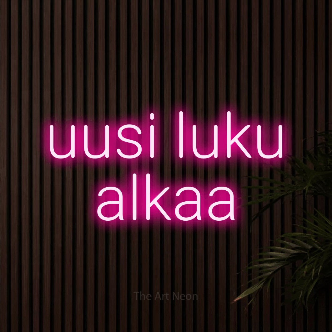 LED neon sign reading “uusi luku alkaa”, arranged in 2 lines.