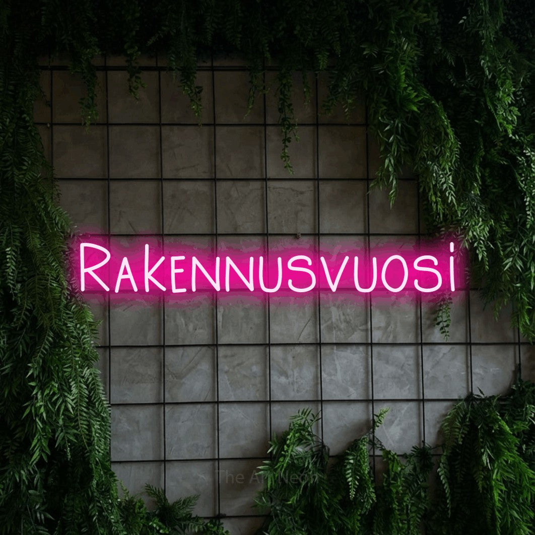 LED neon sign reading “Rakennusvuosi”, arranged in a single line.