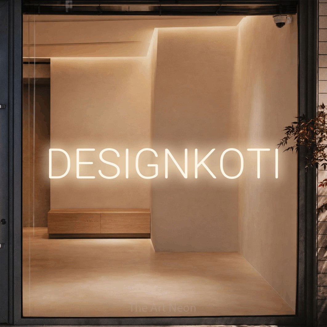 LED neon sign reading “DESIGNKOTI”, arranged in a single line.