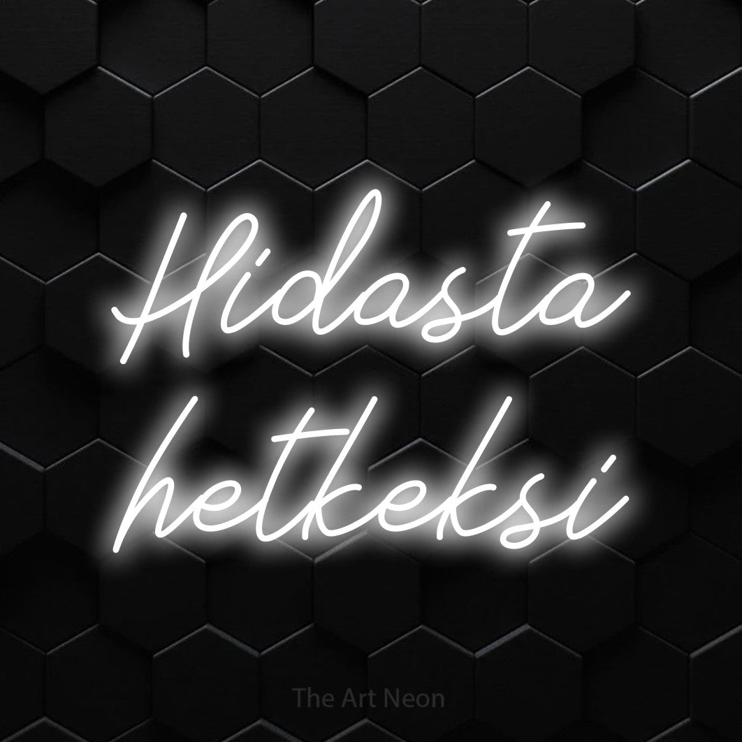 LED neon sign reading “Hidasta hetkeksi”, arranged in 2 lines.