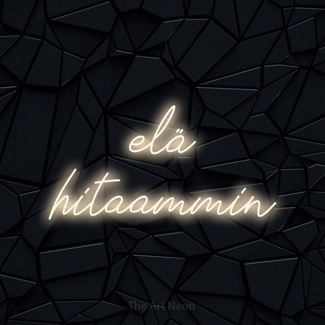 LED neon sign reading “elä hitaammin”, arranged in 2 lines.