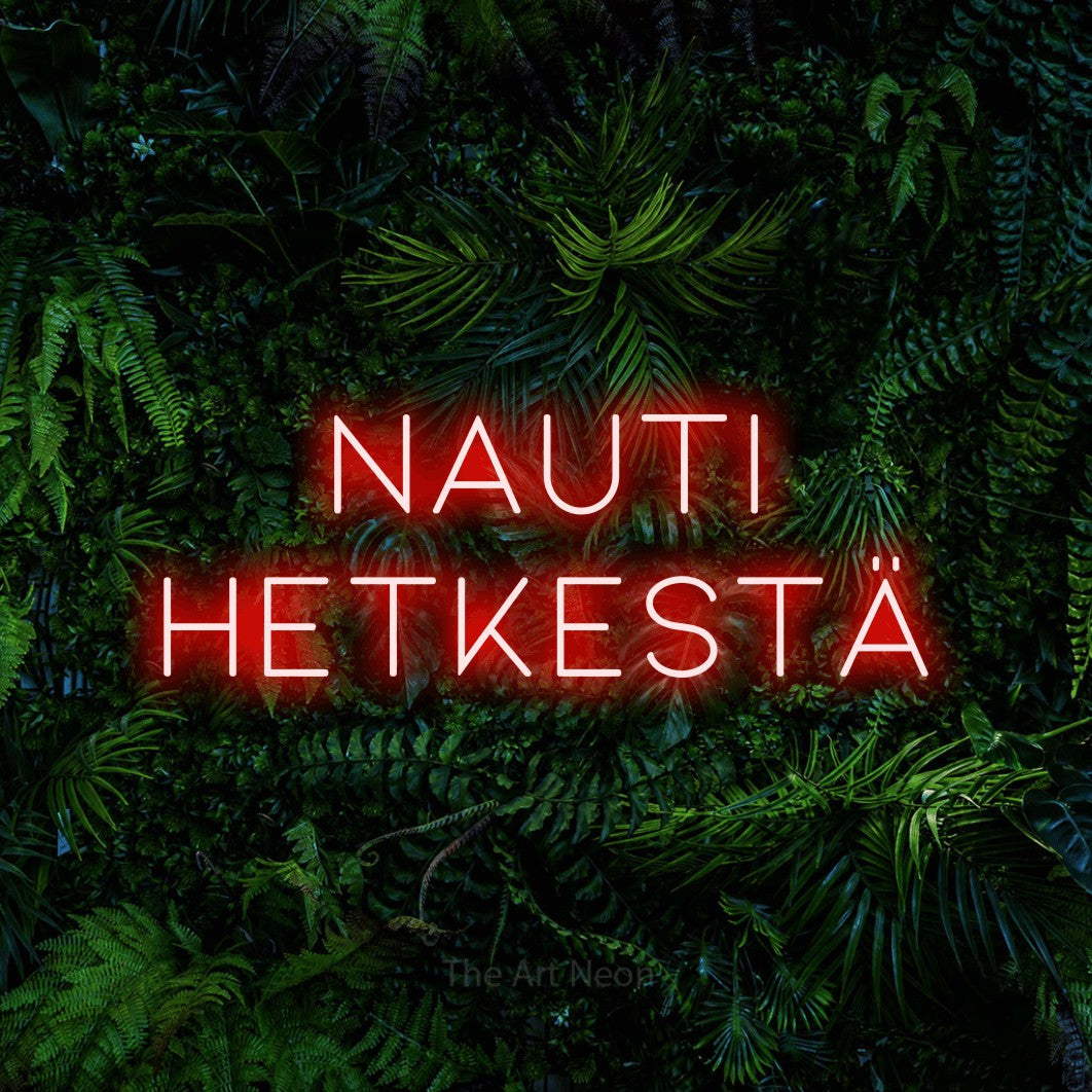 LED neon sign reading “Nauti hetkestä”, arranged in 2 lines.