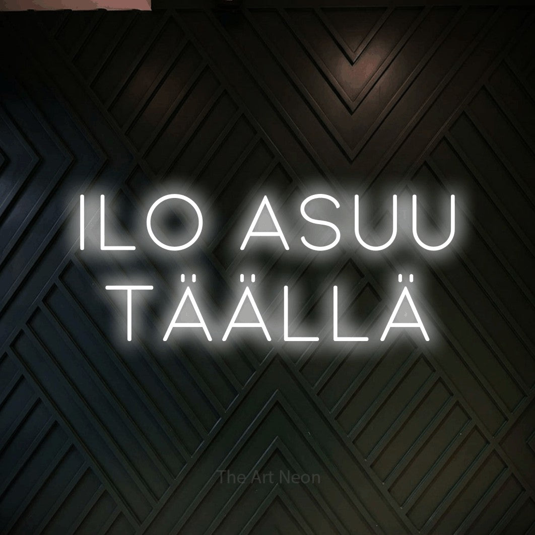 LED neon sign reading “Ilo asuu täällä”, arranged in 2 lines.