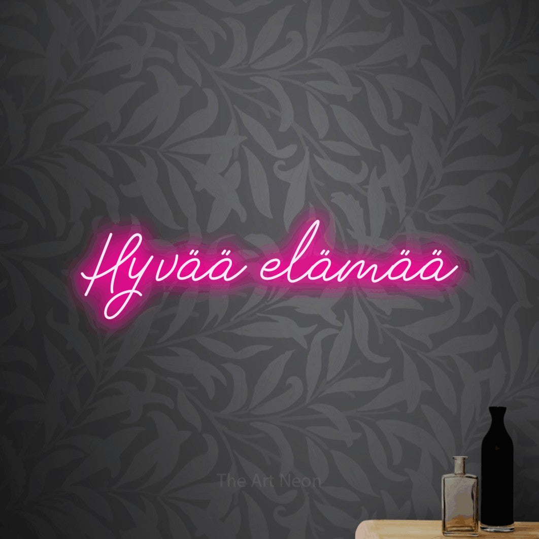 LED neon sign reading “Hyvää elämää”, arranged in a single line.