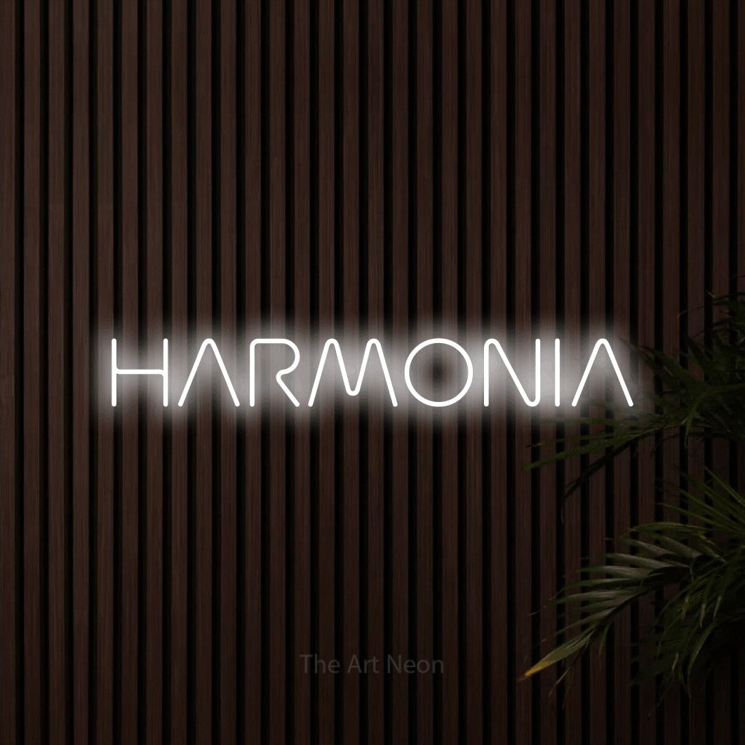 LED neon sign reading “HARMONIA”, arranged in a single line.