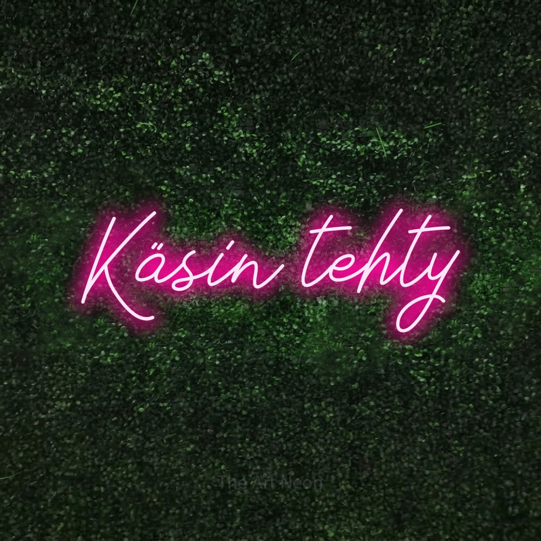 LED neon sign reading “Käsin tehty”, arranged in a single line.