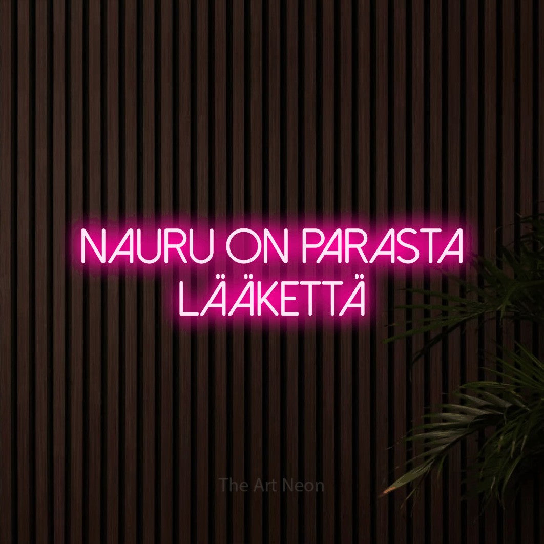 LED neon sign reading “nauru on parasta lääkettä”, arranged in 2 lines.