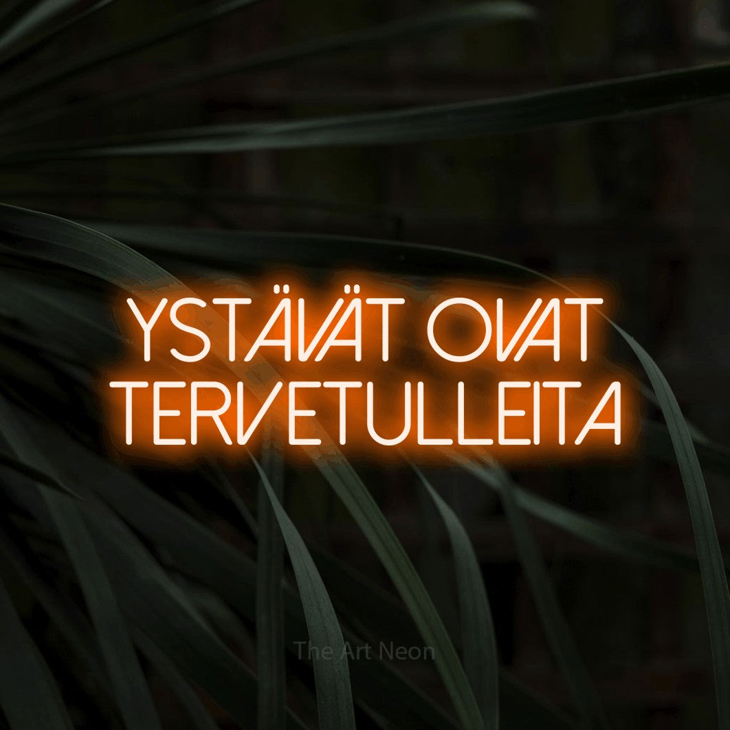LED neon sign reading “Ystävät ovat tervetulleita”, arranged in 2 lines.