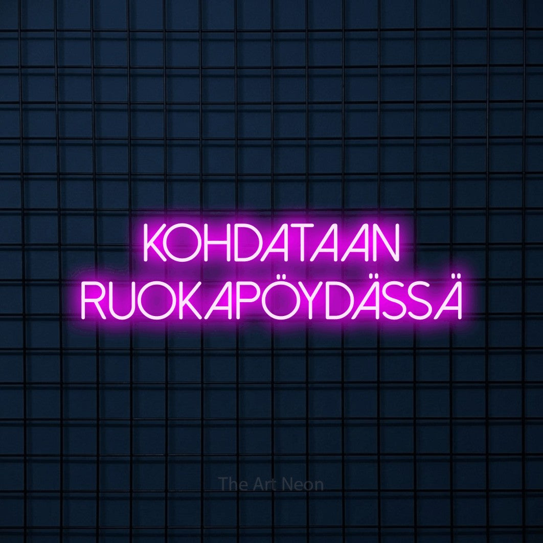 LED neon sign reading “kohdataan ruokapöydässä”, arranged in 2 lines.