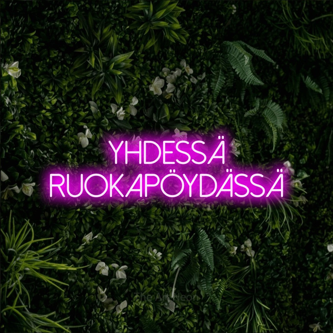 LED neon sign reading “yhdessä ruokapöydässä”, arranged in 2 lines.