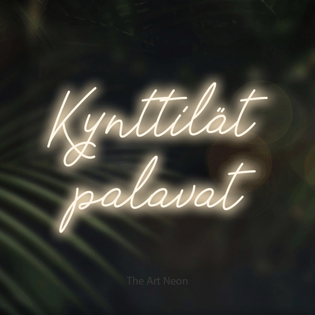 LED neon sign reading “Kynttilät palavat”, arranged in 2 lines.
