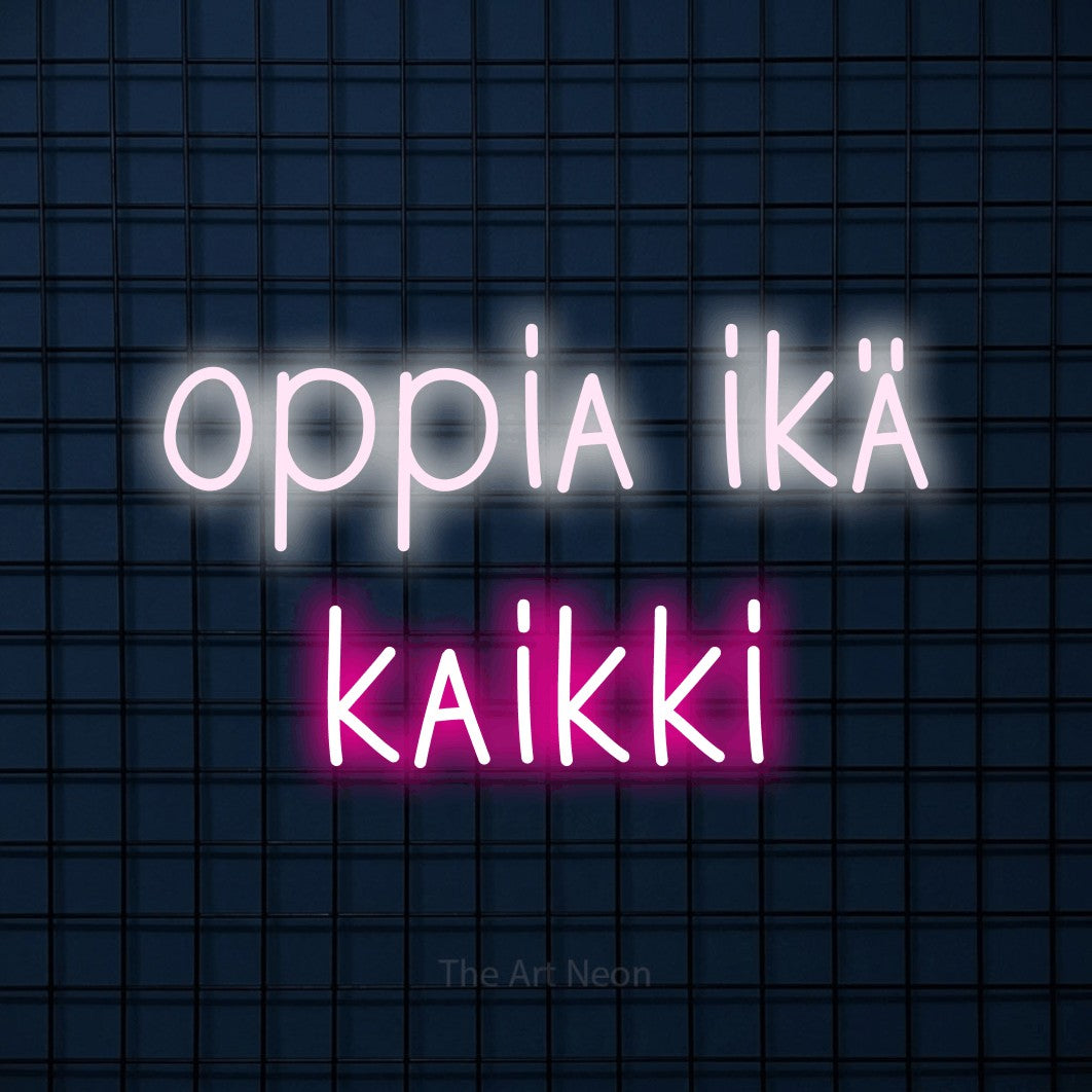 LED neon sign reading “oppia ikä kaikki”, arranged in 2 lines.