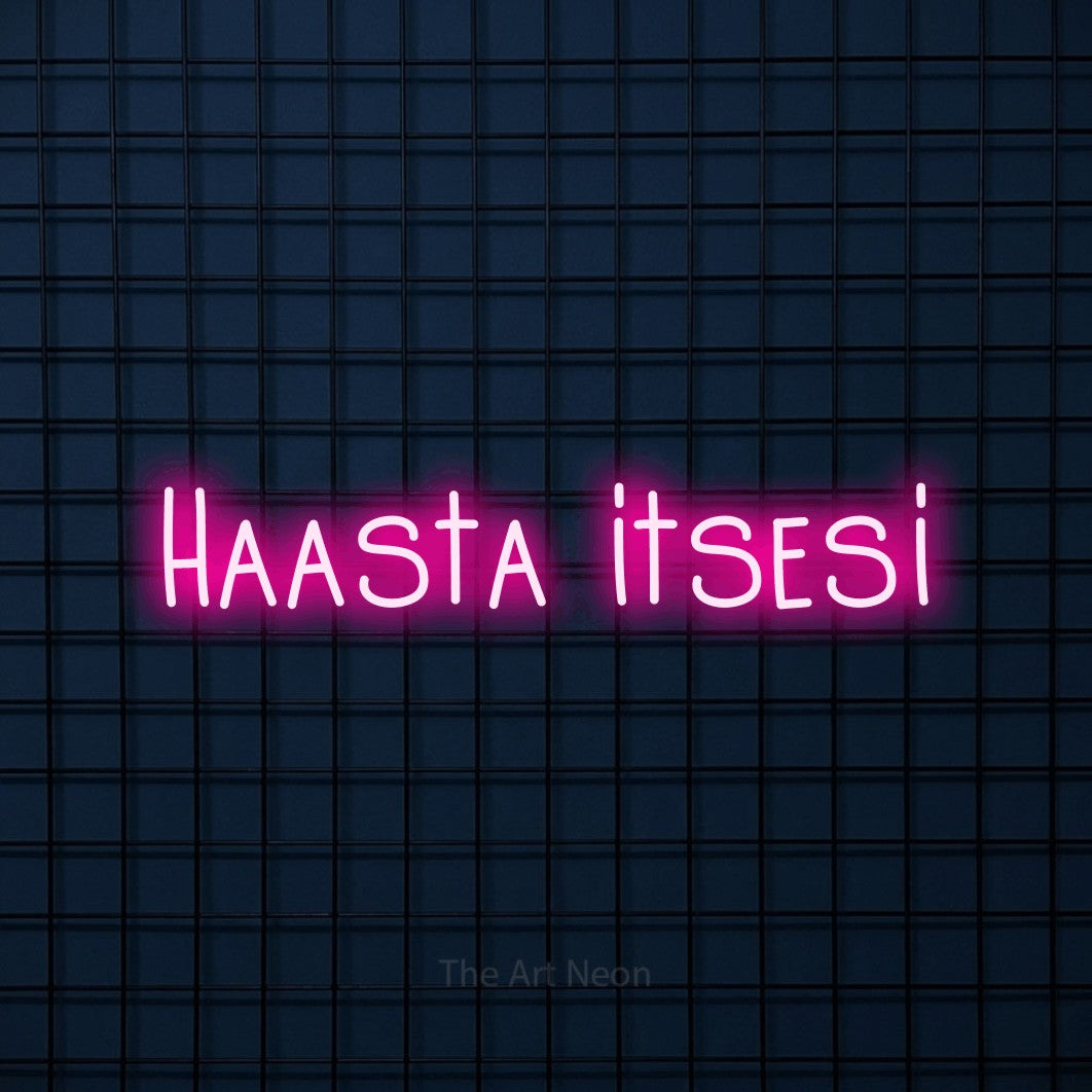 LED neon sign reading “Haasta itsesi”, arranged in a single line.