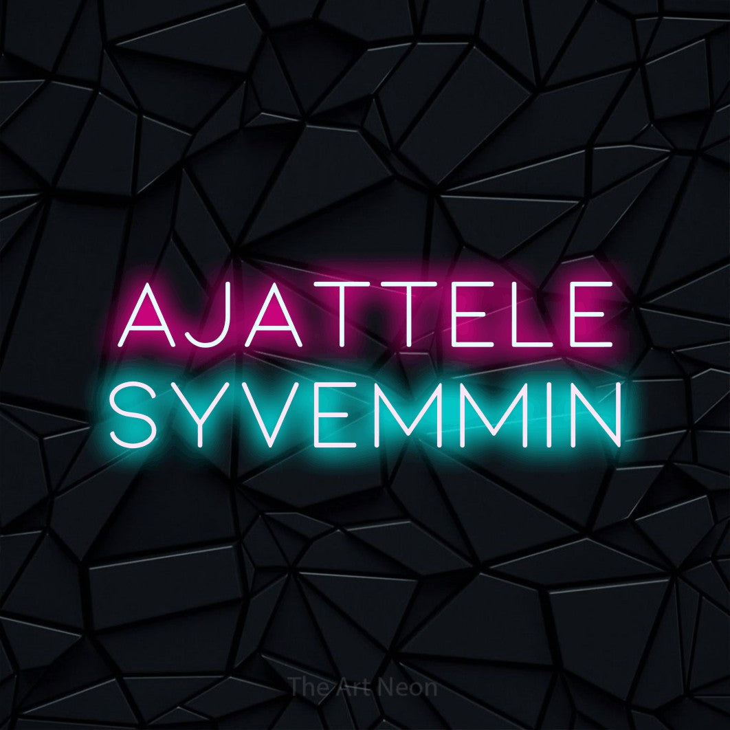 LED neon sign reading “AJATTELE SYVEMMIN”, arranged in 2 lines.