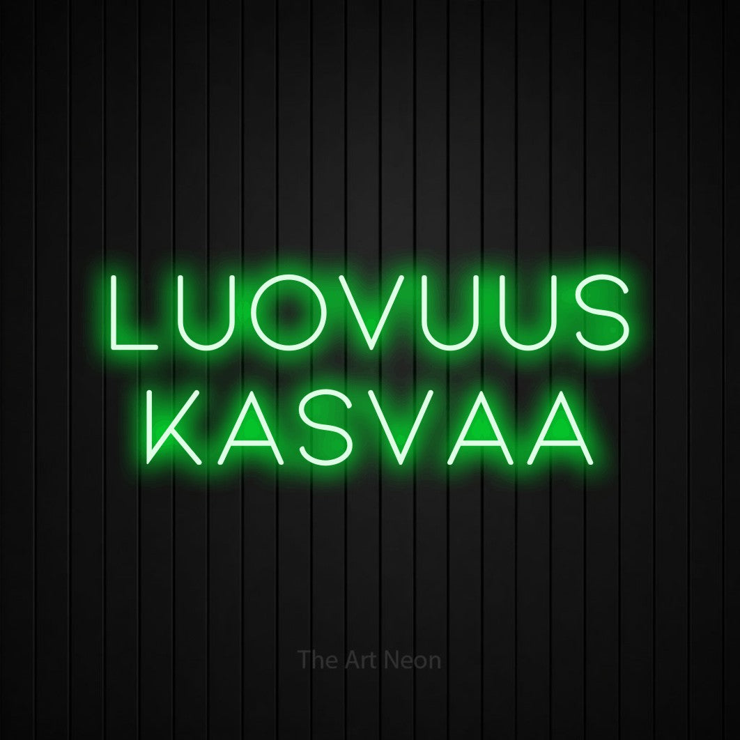 LED neon sign reading “Luovuus kasvaa”, arranged in 2 lines.