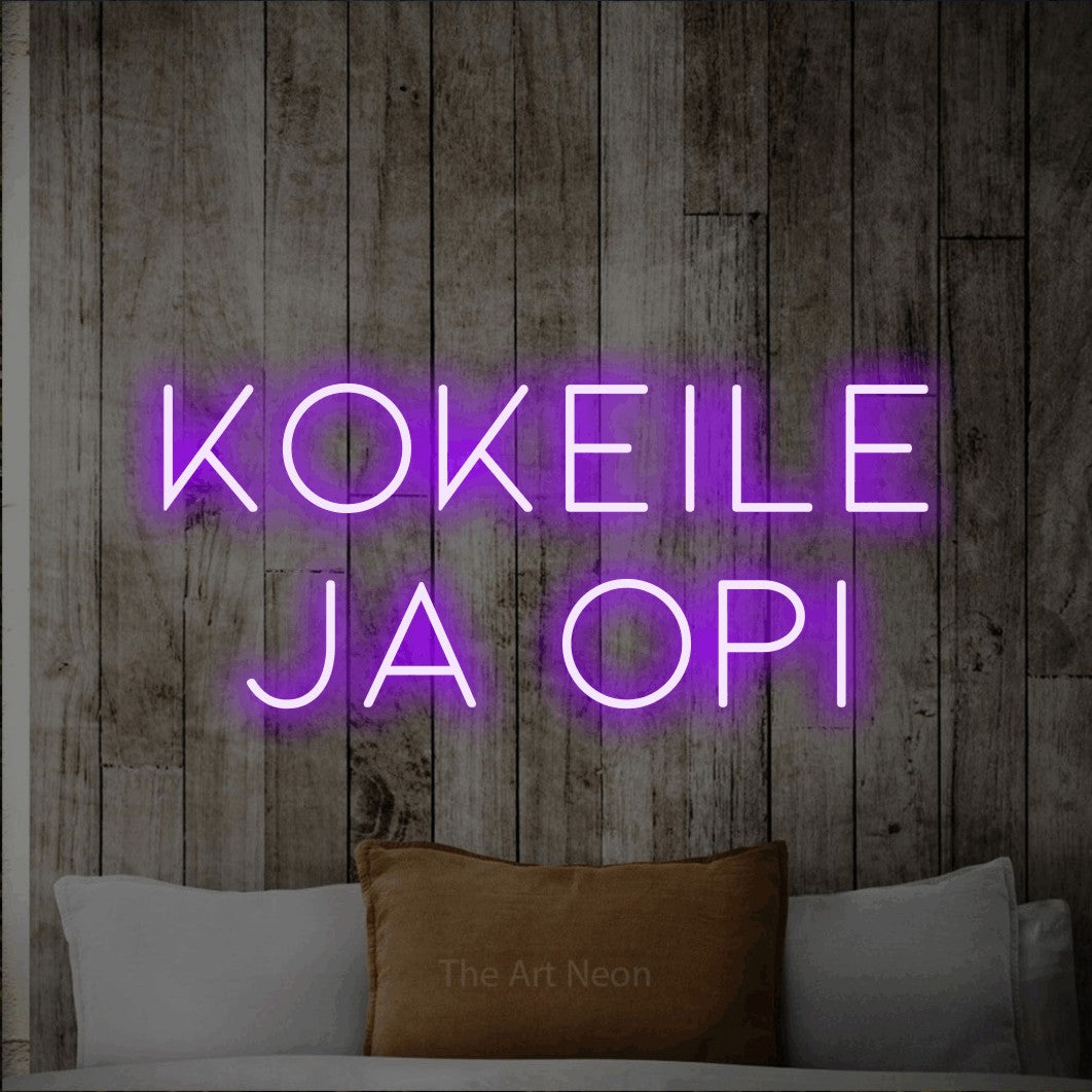 LED neon sign reading “kokeile ja opi”, arranged in 2 lines.