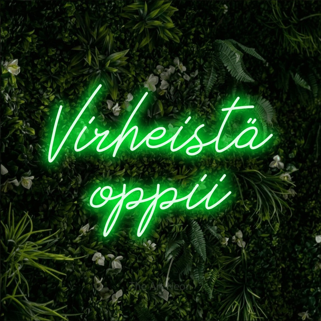 LED neon sign reading “Virheistä oppii”, arranged in 2 lines.