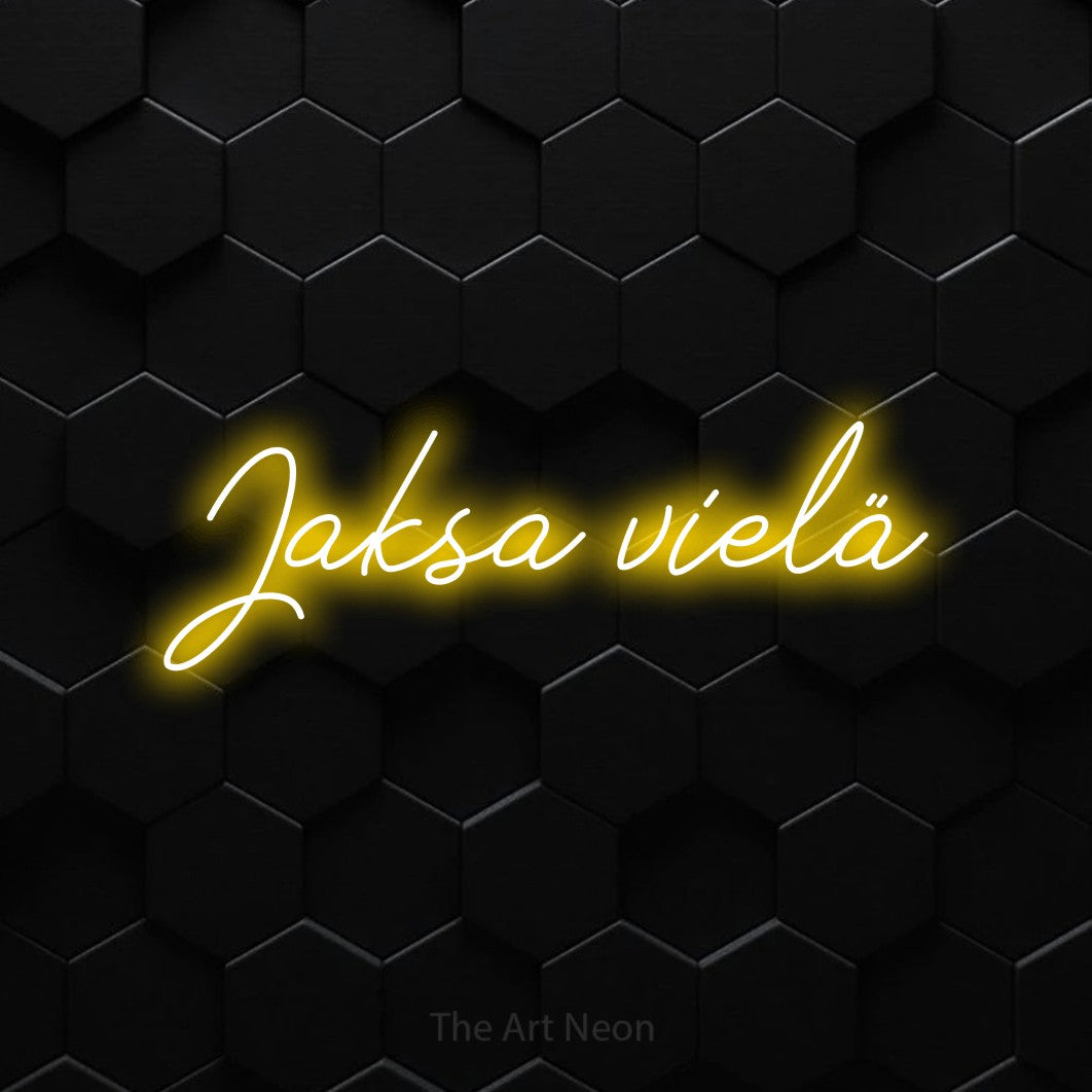 LED neon sign reading “Jaksa vielä”, arranged in a single line.
