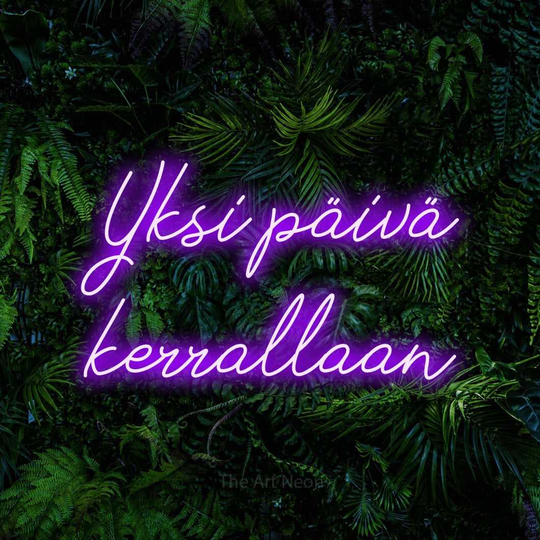 LED neon sign reading “Yksi päivä kerrallaan”, arranged in 2 lines.