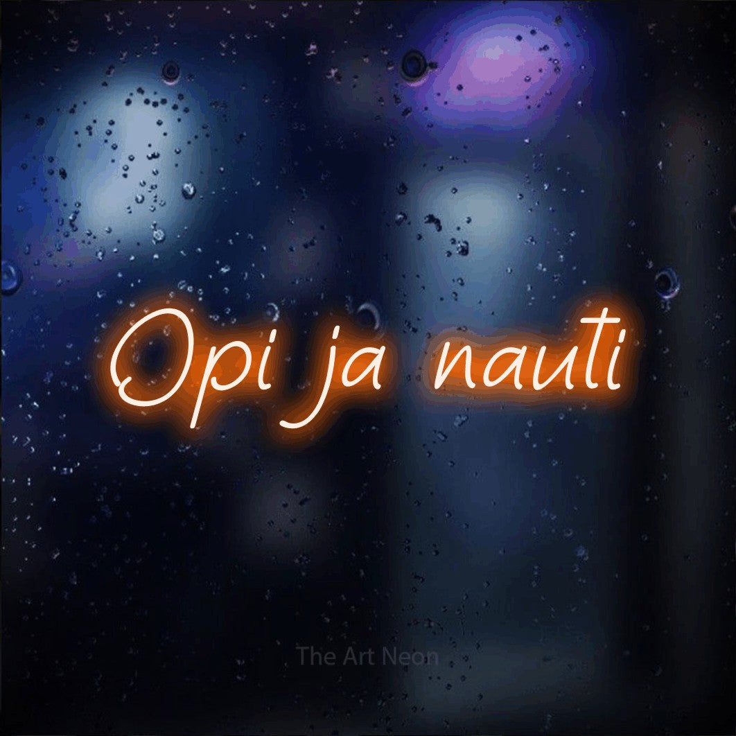 LED neon sign reading “Opi ja nauti”, arranged in a single line.