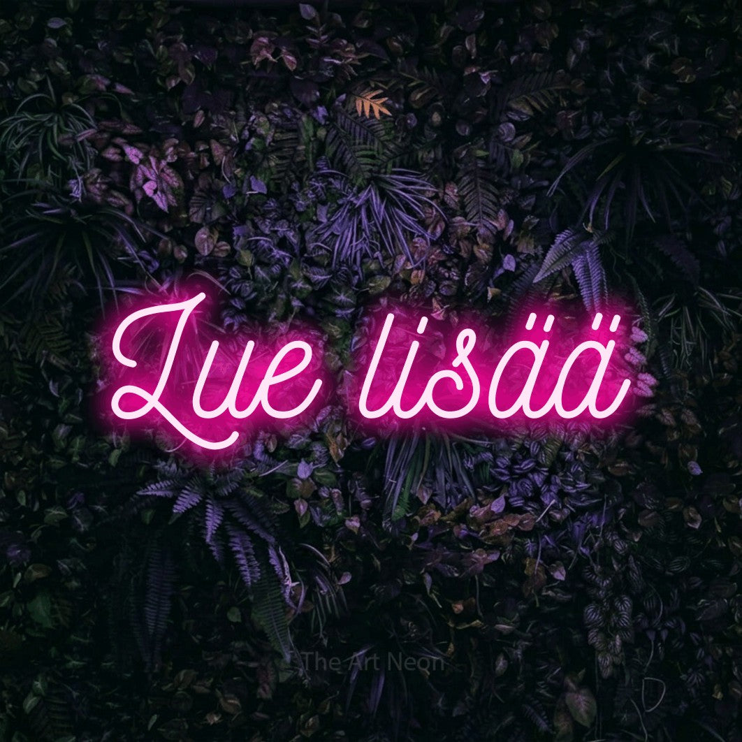 LED neon sign reading “Lue lisää”, arranged in a single line.