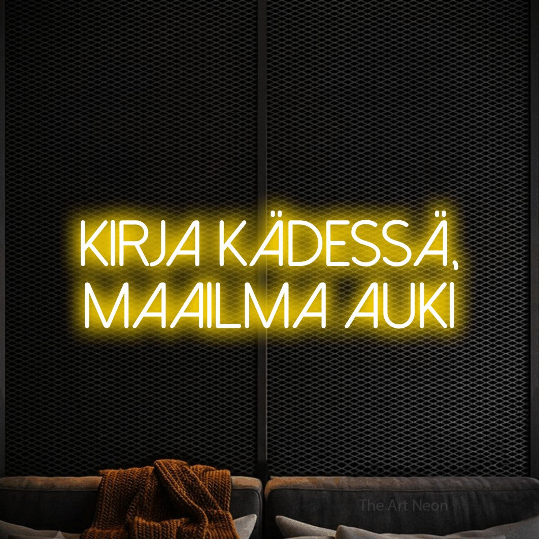 LED neon sign reading “kirja kädessä, maailma auki”, arranged in 2 lines.