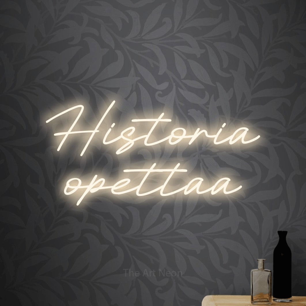 LED neon sign reading “Historia opettaa”, arranged in 2 lines.