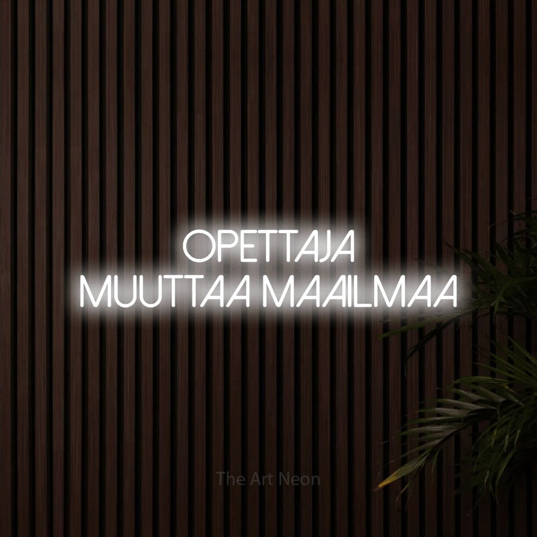 LED neon sign reading “Opettaja muuttaa maailmaa”, arranged in 2 lines.