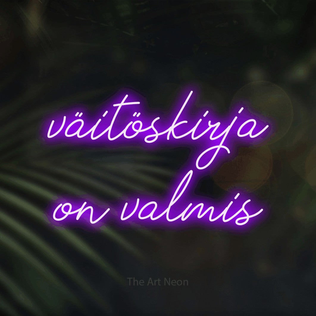 LED neon sign reading “väitöskirja on valmis”, arranged in 2 lines.