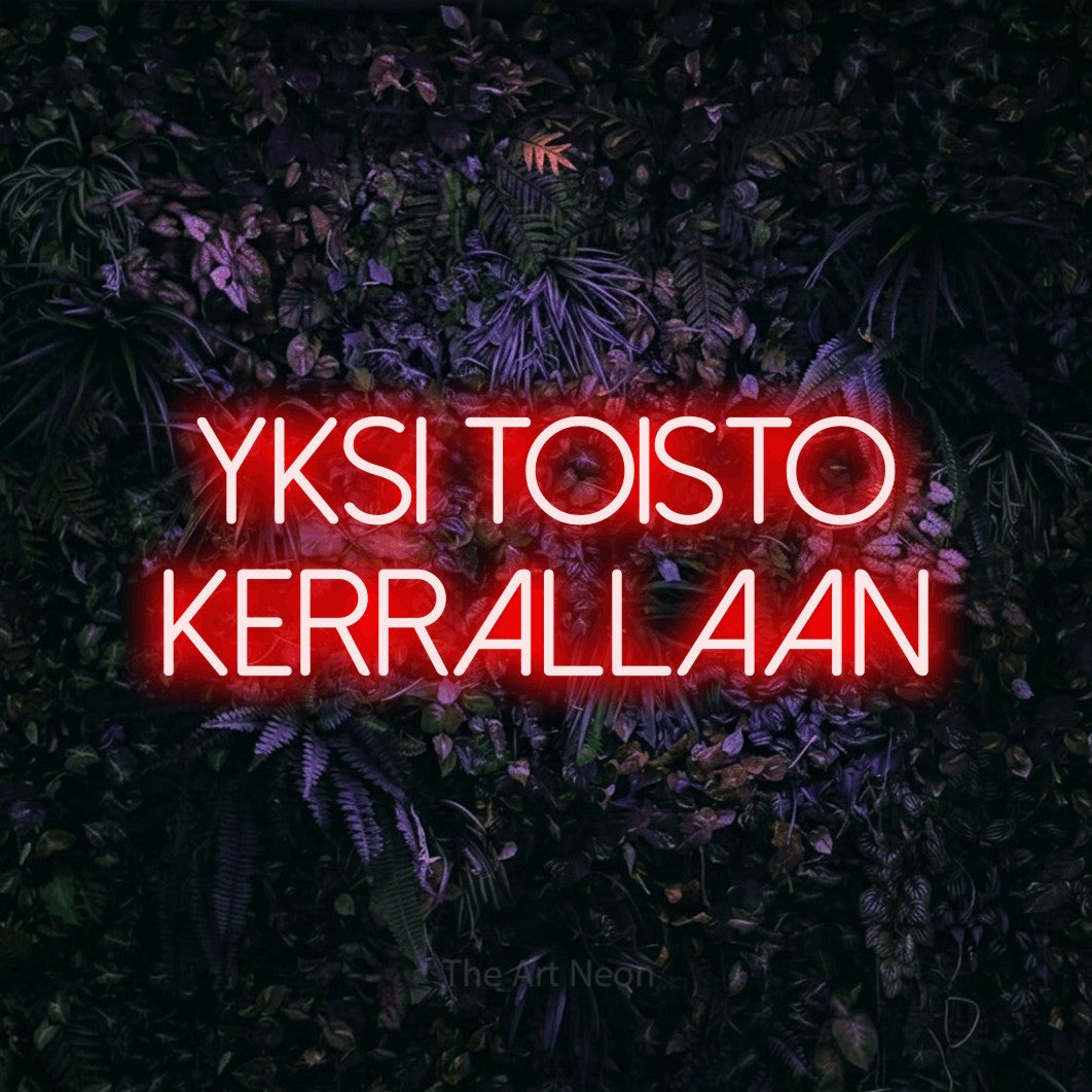 LED neon sign reading “YKSI TOISTO KERRALLAAN”, arranged in 2 lines.