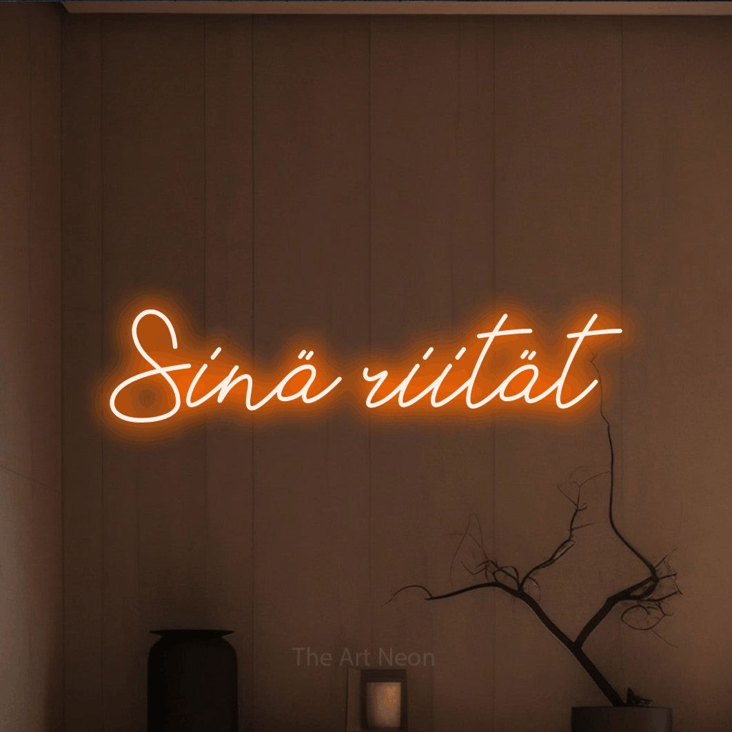 LED neon sign reading “Sinä riität”, arranged in a single line.