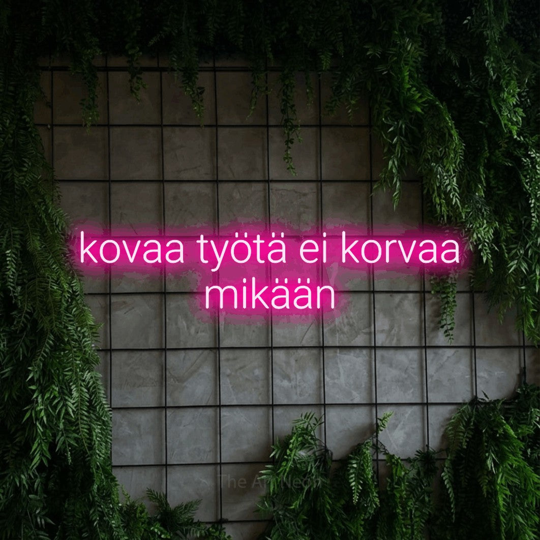 LED neon sign reading “kovaa työtä ei korvaa mikään”, arranged in 2 lines.