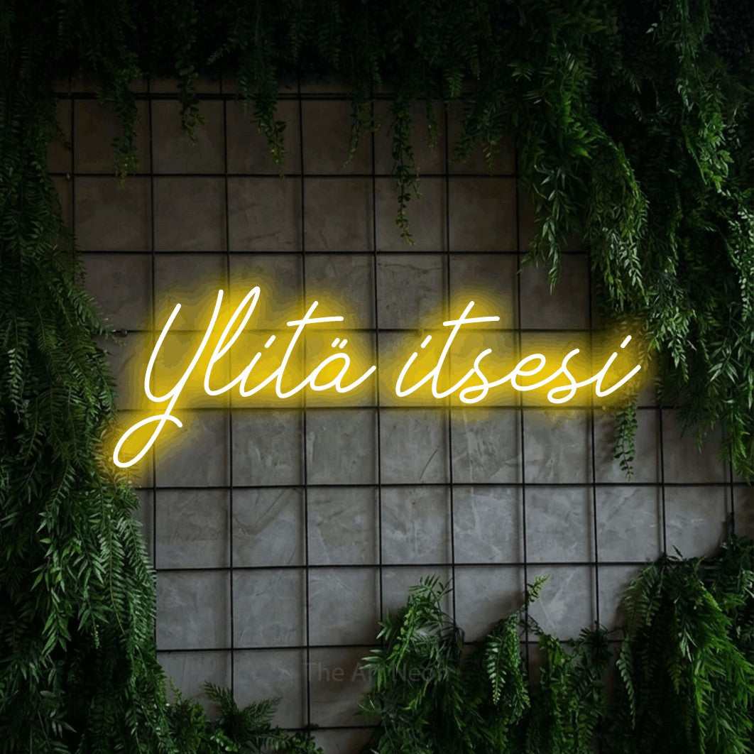 LED neon sign reading “Ylitä itsesi”, arranged in a single line.