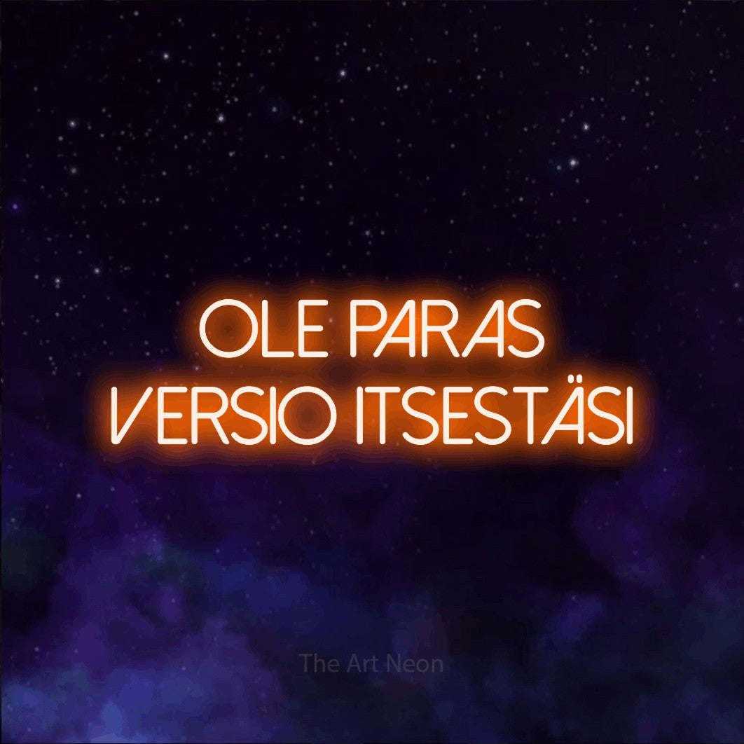 LED neon sign reading “Ole paras versio itsestäsi”, arranged in 2 lines.