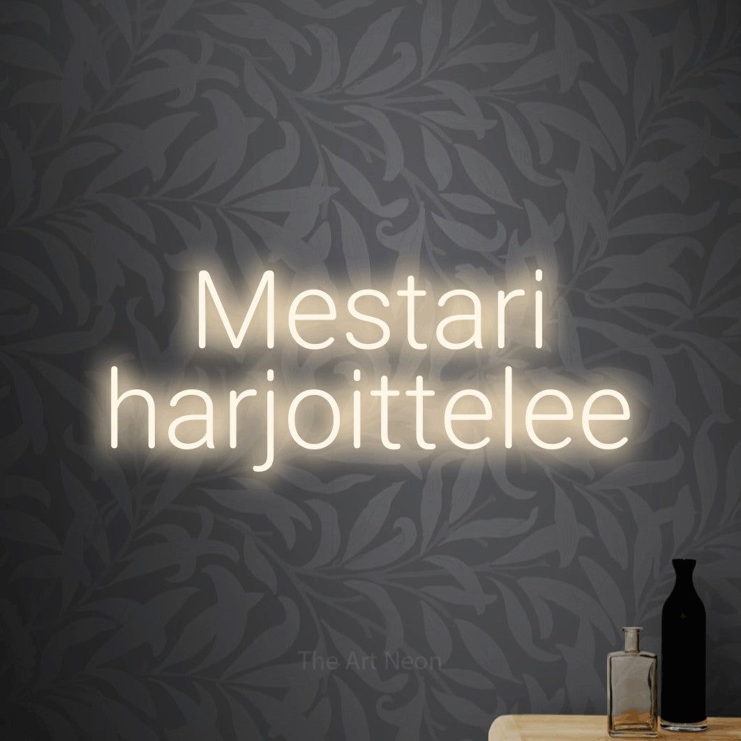 LED neon sign reading “Mestari harjoittelee”, arranged in 2 lines.