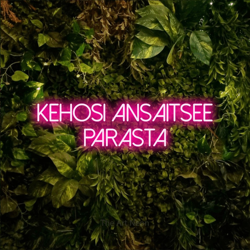 LED neon sign reading “kehosi ansaitsee parasta”, arranged in 2 lines.