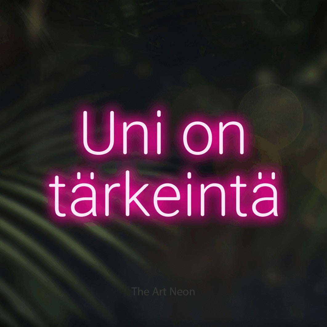LED neon sign reading “Uni on tärkeintä”, arranged in 2 lines.