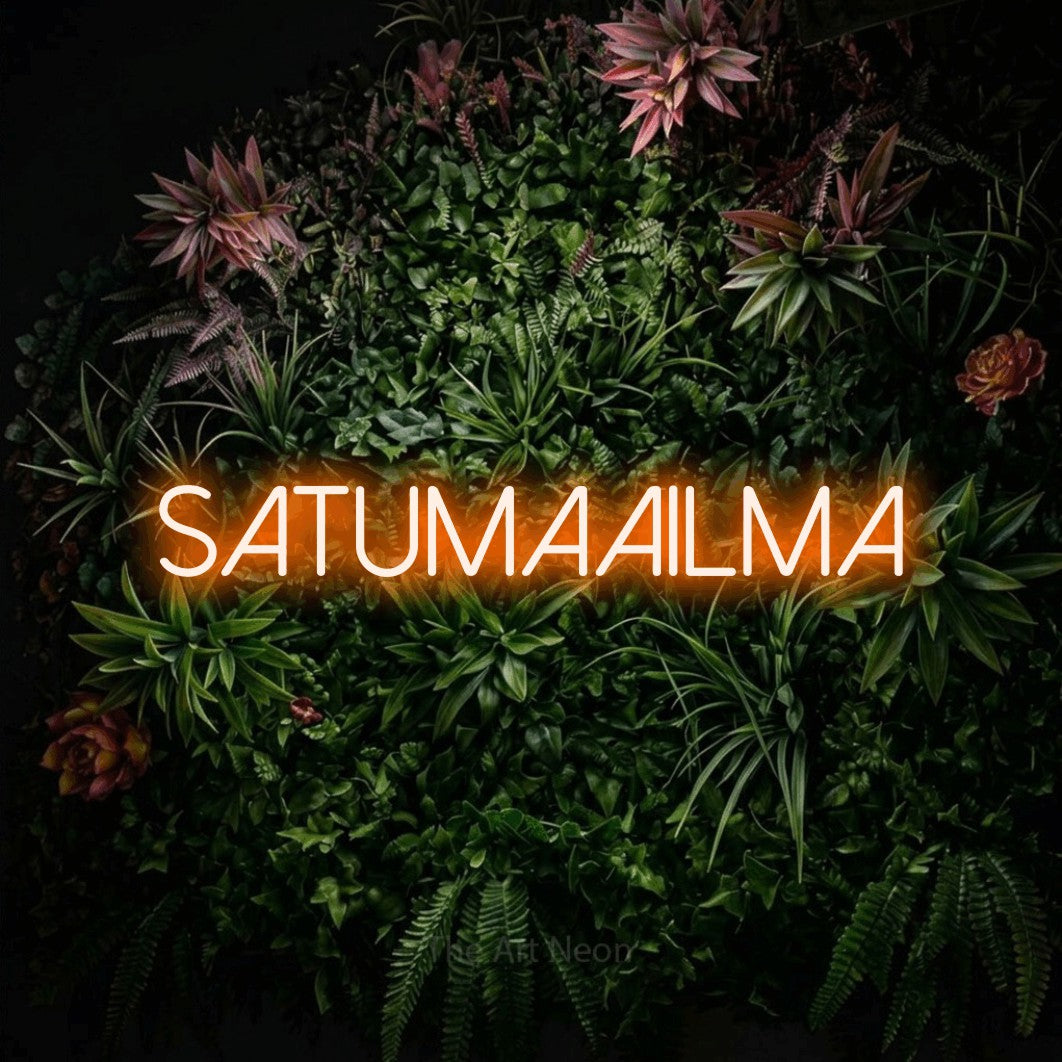 LED neon sign reading “SATUMAAILMA”, arranged in a single line.