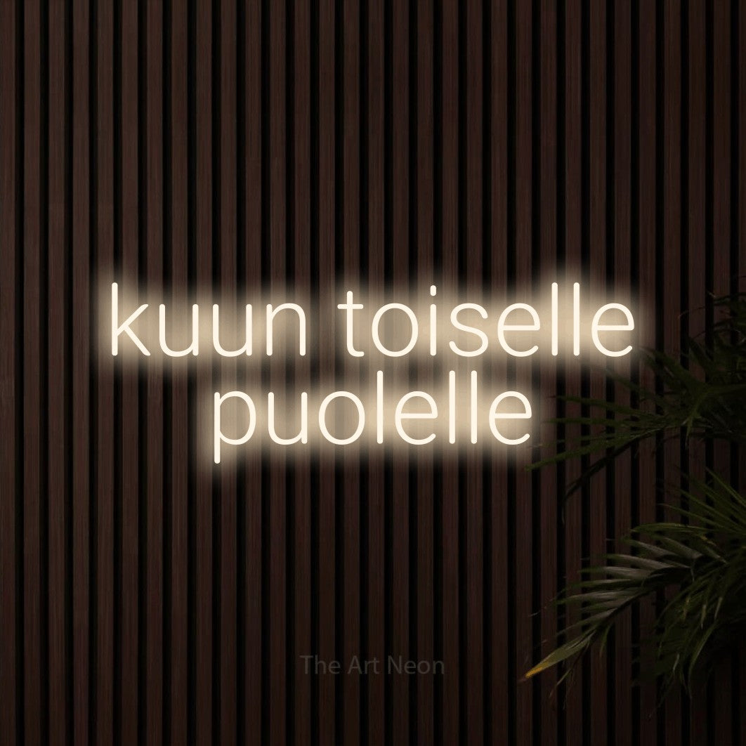 LED neon sign reading “kuun toiselle puolelle”, arranged in 2 lines.