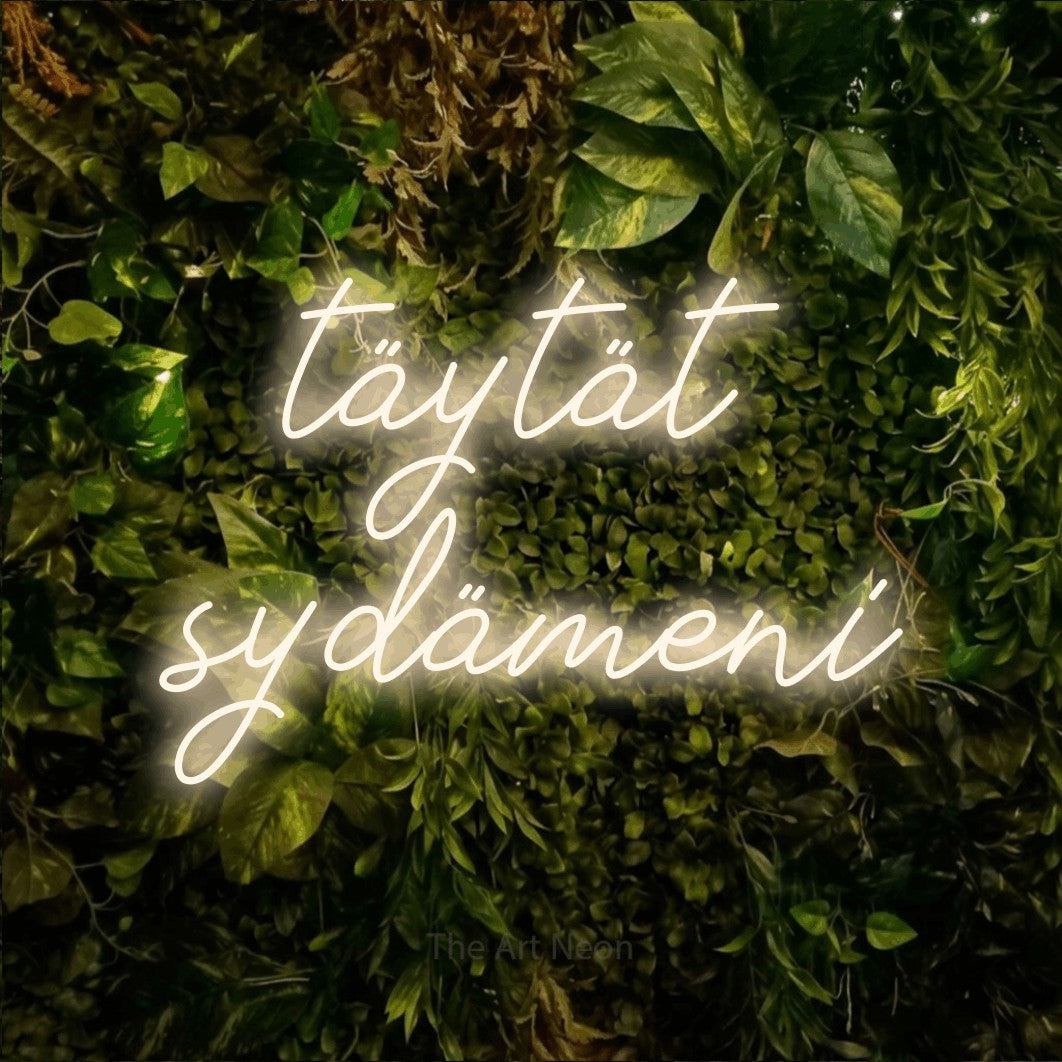 LED neon sign reading “täytät sydämeni”, arranged in 2 lines.